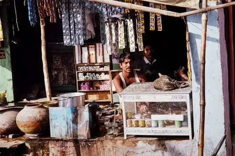 A small business owner using accounting software on a computer in a shop