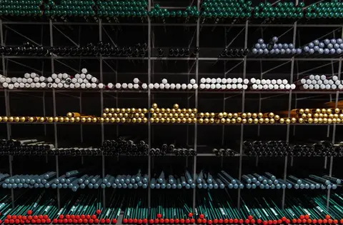 Shelves stocked with stationery items in a small Indian shop, representing closing stock still owned by the business.