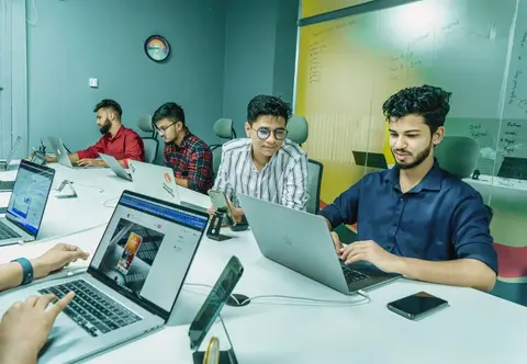 A small team of young entrepreneurs working together in an Indian startup office
