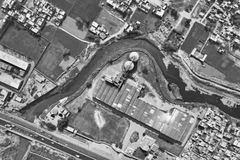 An empty or under-used factory building representing industrial stagnation due to political instability