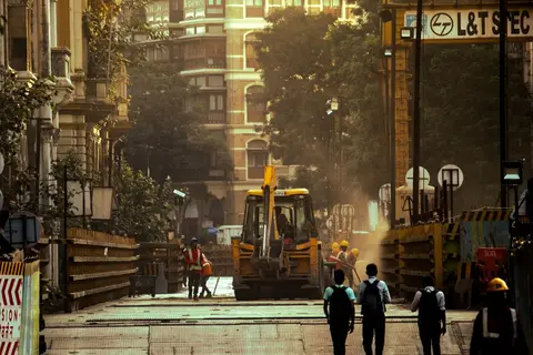Construction workers at a building site in an Indian city, representing rural migrants in informal urban jobs.