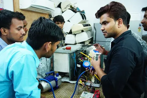 Young men and women learning a vocational skill in a training centre in India.