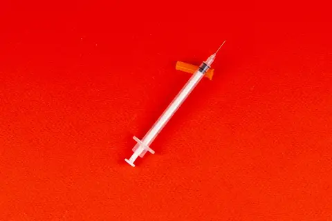 A health worker vaccinating a child at a rural vaccination camp in India