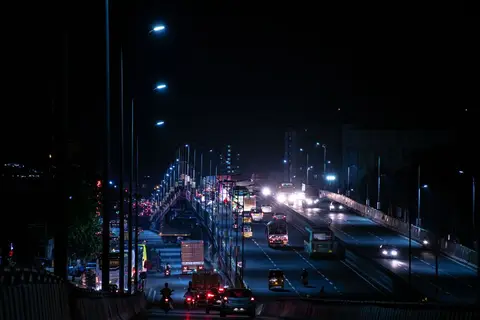 Trucks moving on an Indian highway at night, showing goods in transit
