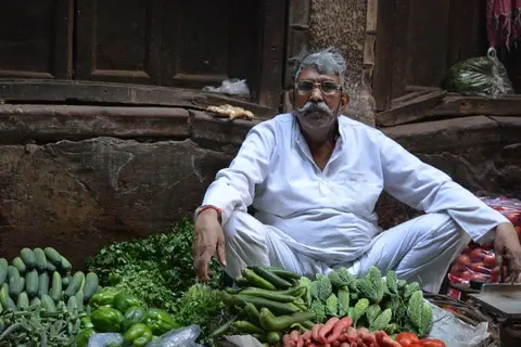 A vendor at an Indian vegetable market, illustrating the mixed impact of globalisation on small traders