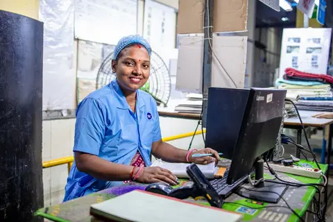 An ASHA health worker visiting a family in a rural Indian village