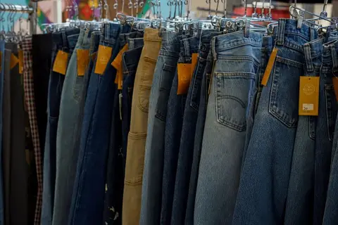 Clothing rack showing garments tagged with S, M, L, XL size labels