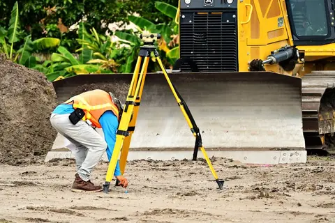 A government survey worker collecting data from a rural Indian household.
