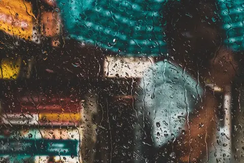 Heavy monsoon rain on a Kerala street, showing extreme weather variation