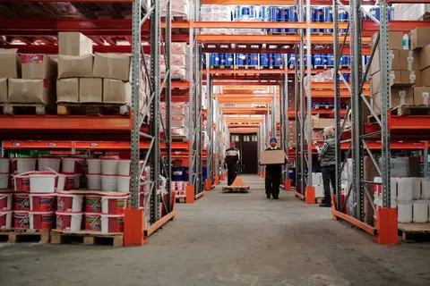 A large wholesale warehouse in India with stacked goods ready for distribution to retailers