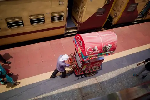 An ice cream vendor on a hot Indian street, illustrating summer driving multiple trends at once.