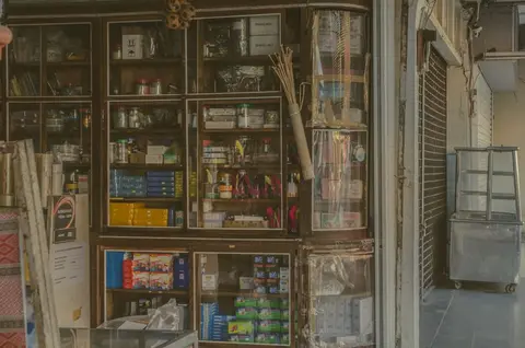 A traditional Indian kirana store with shelves stacked with packaged goods
