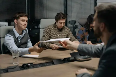 A family meeting to discuss business handover, representing a legal heir receiving a deceased partner's dues