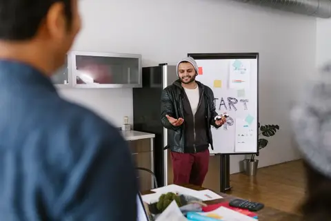 A small team collaborating in a casual Indian startup office setting