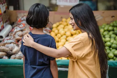An Indian family shopping for fresh vegetables and healthy food at a market