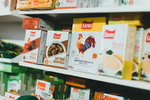 Shelves of branded products at a small Indian kirana store.