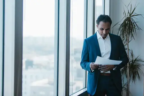 A business owner reviewing and adjusting plans at a desk