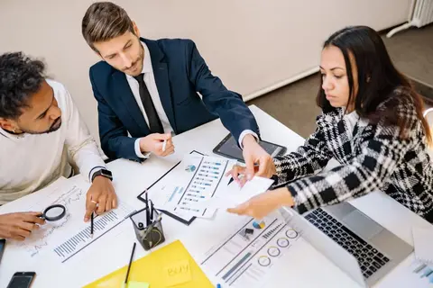Manager revising a business plan document at a desk
