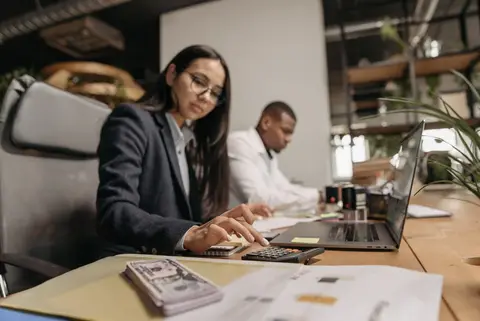 A small team of accountants working at desks in an Indian office