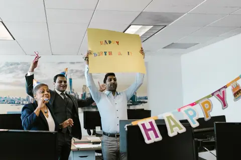 A diverse group of Indian office workers celebrating together