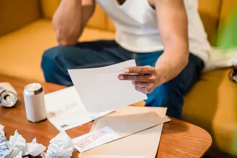 A business person looking stressed, representing the burden of a dishonoured payment obligation