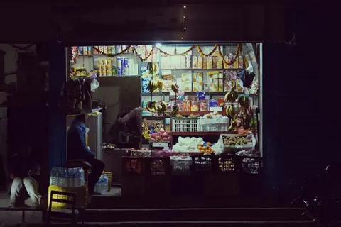 A small Indian kirana store open and running, showing shelves stocked with goods.