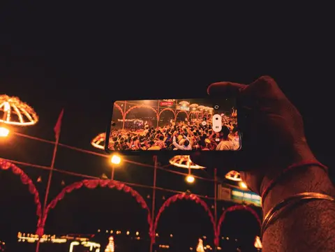 People in India using smartphones, representing affordable data access brought by market competition