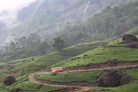 A KSRTC bus travelling on a rural road in Kerala