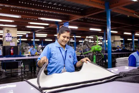 Workers on a car assembly line at a Maruti Suzuki factory in India