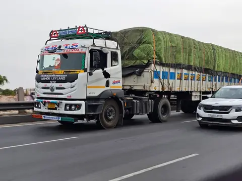 A loaded cargo truck driving on an Indian highway.