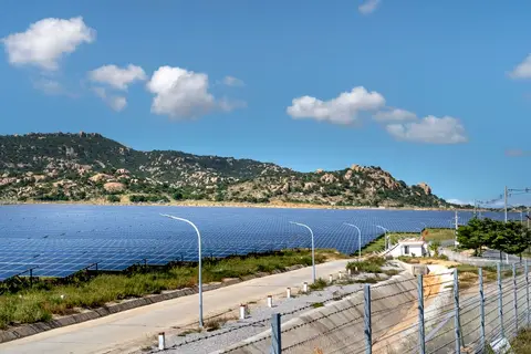 Solar panels installed in a field in India representing clean energy investment