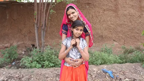 A young person in a rural Indian setting using a smartphone, illustrating the transformation in connectivity after telecom liberalisation